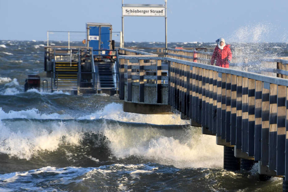 Hohe Wellen treffen an der Seebrücke auf den Schönberger Strand bei Kiel.