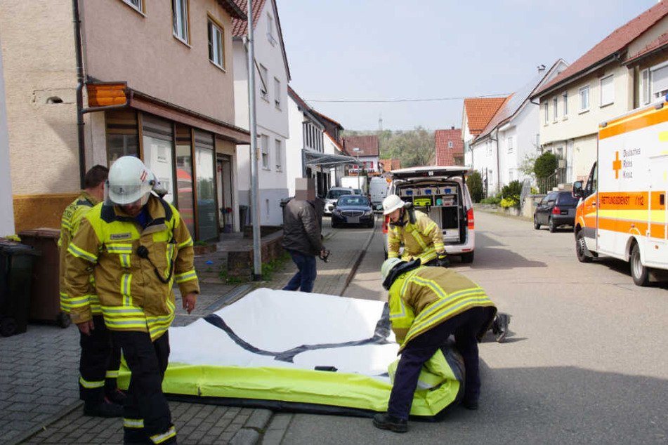 Die Feuerwehr bereitete ein Sprungtuch unter dem Fenster vor, auf das der Mann später sprang.