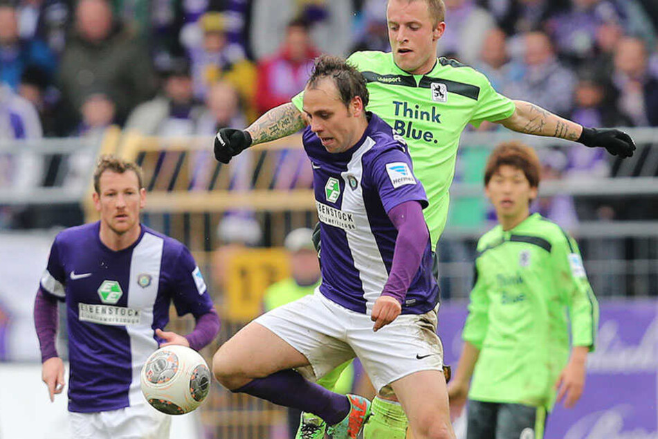 Rico Benatelli (vorn) im März 2014 im Trikot des FC Erzgebirge Aue bei einem Zweikampf mit Daniel Adlung vom TSV 1860 München.