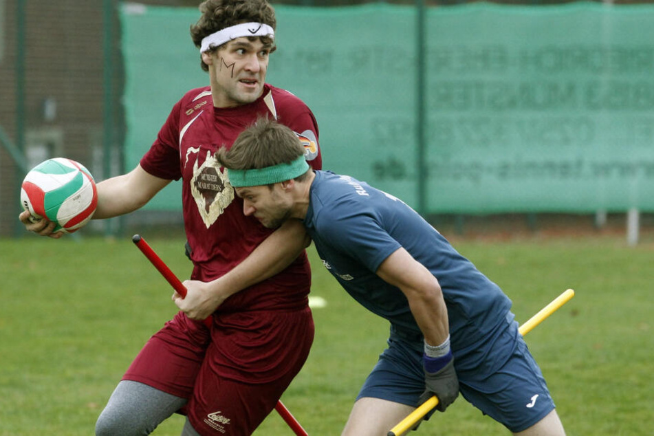 Zwei Spieler kämpfen während eines Quidditch-Spiels um den Ball.
