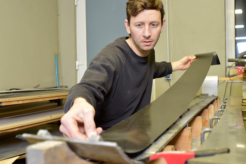 Alles in Handarbeit: André Voigt legt eine Carbonplatte in die Skiform ein.
Später wandert diese in die Pressmaschine