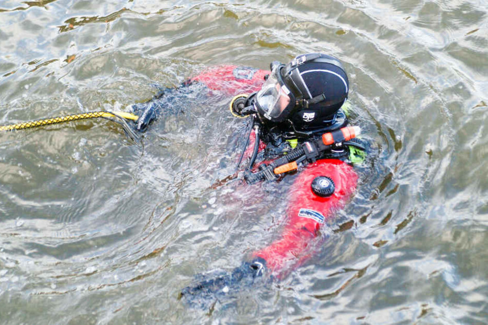 Taucher der Feuerwehr suchen am Grund der Elbe nach dem Vermissten.
