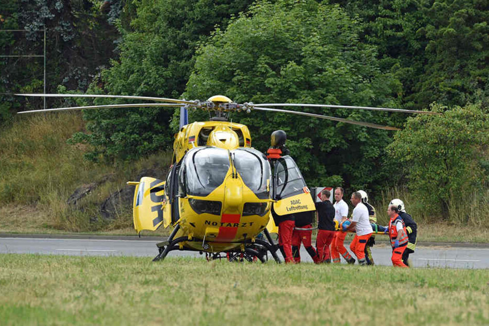 Sanitäter bringen den Familienvater zum Rettungshubschrauber.