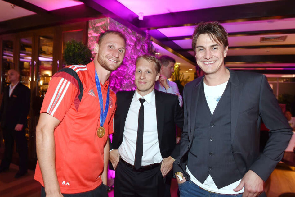 Oliver Pocher (m) und Matze Knop (r) mit Nationalspieler Benedikt Höwedes nach dem Gewinn des WM-Titels in Rio am 13. Juli 2014.