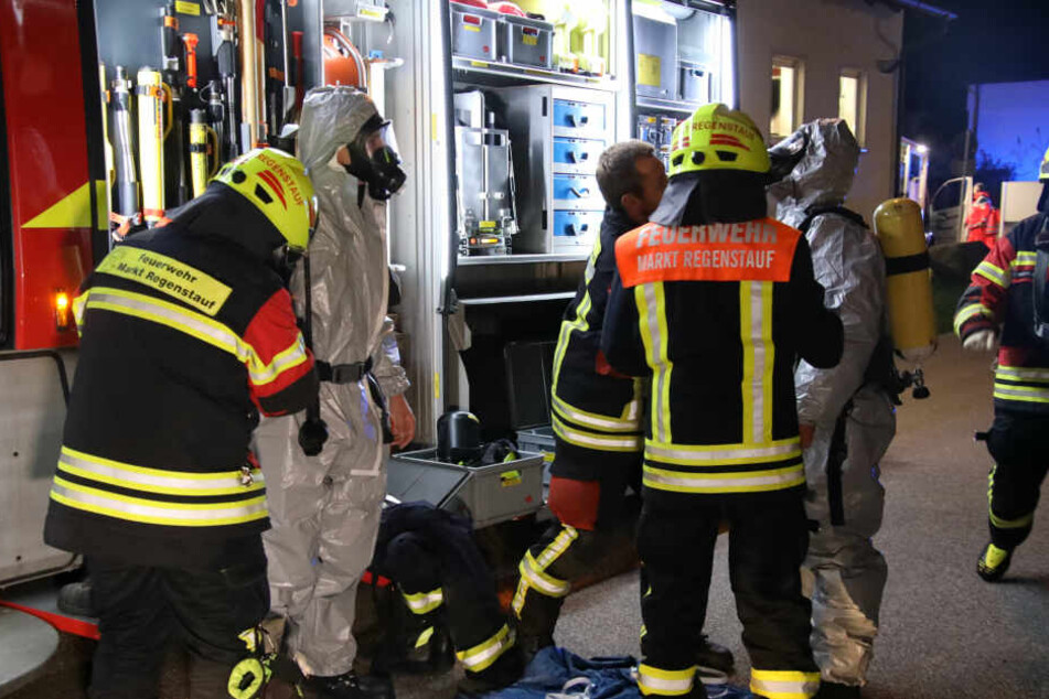 Die Feuerwehrleute machen sich für ihren Einsatz am Wohnhaus bereit.
