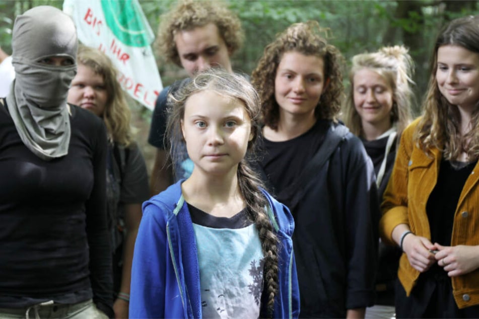 Greta Thunberg (Mitte), links von ihr eine vermummte Aktivistin im Hambacher Forst.