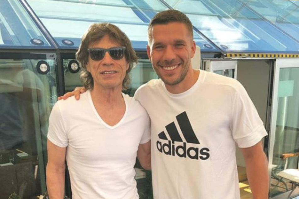Ehrengast Mick Jagger und Weltmeister 2014 Lukas Podolski.