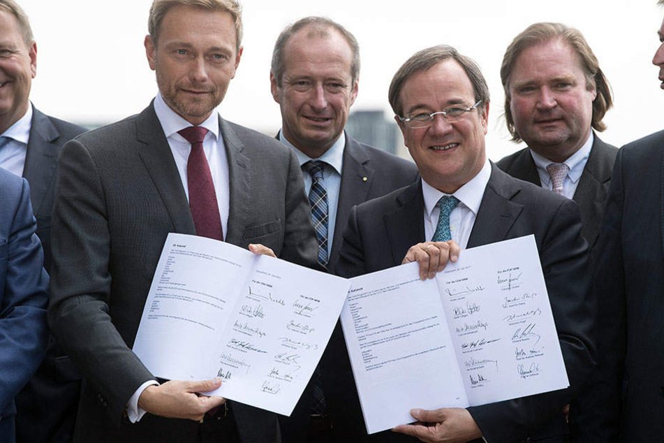 Christian Lindner (l., FDP) und Armin Laschet (CDU) zeigen den unterschriebenen Vertrag.