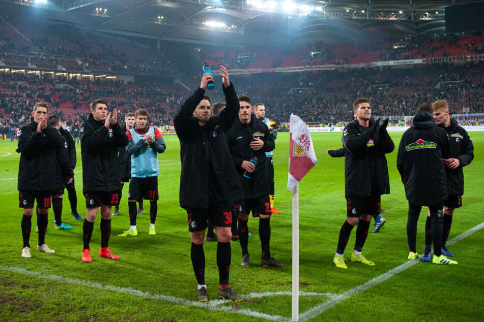 Freiburgs Spieler freuen sich nach dem 2:2 gegen den VfB Stuttgart im Stadion.