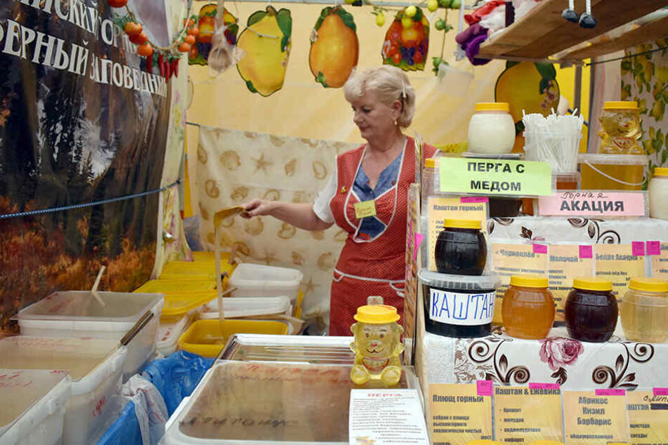 Natalia Kolos steht beim Honig-Jahrmarkt in Moskau an ihrem Verkaufsstand.