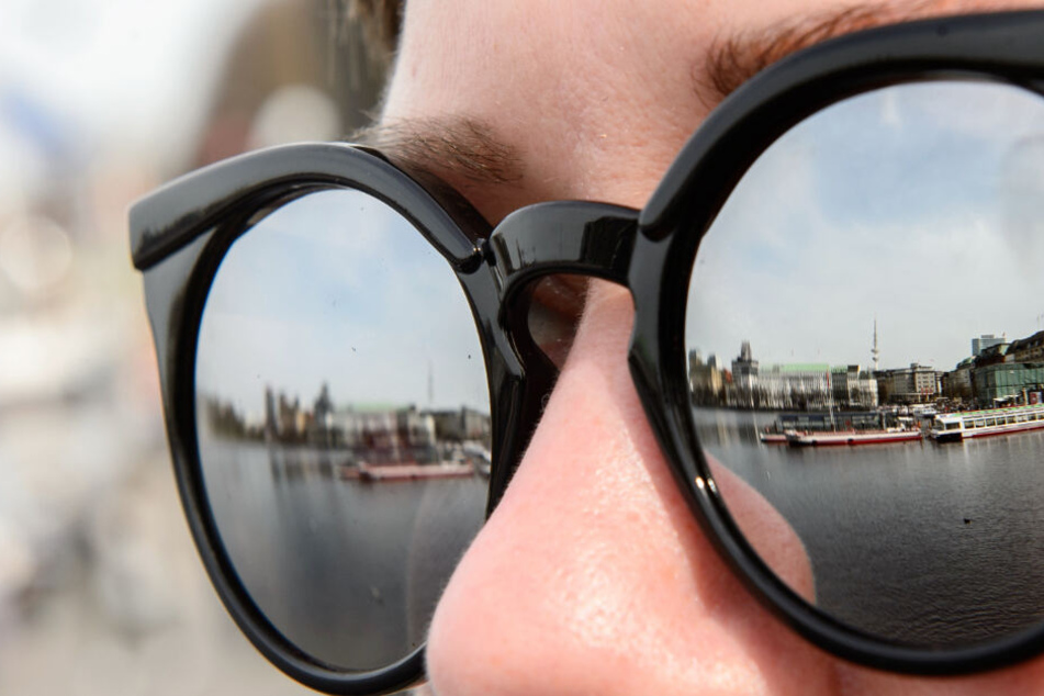 In den Gläsern einer Sonnebrille spiegelt sich die Binnenalster. Am Wochenende solltet Ihr unbedingt an dieses Accessoir denken.