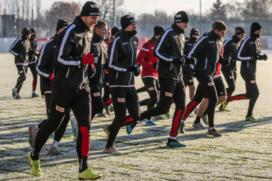 Die Teamkollegen von Sebastian Polter (l) laufen sich warm.
