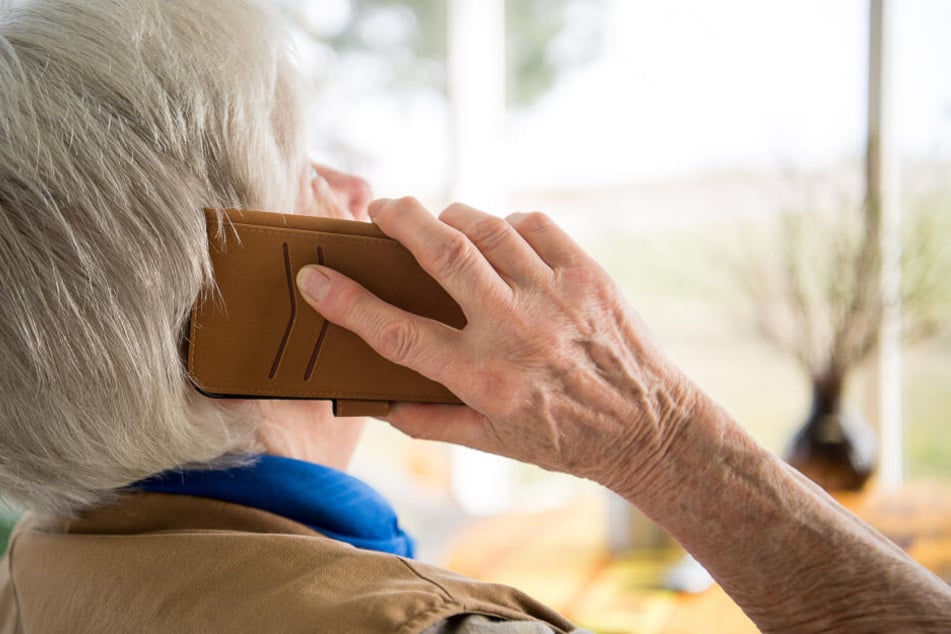 Eine Seniorin telefoniert mit ihrem Smartphone: Bei Betrugsmaschen werden oft ältere Menschen Opfer. (Symbolbild)