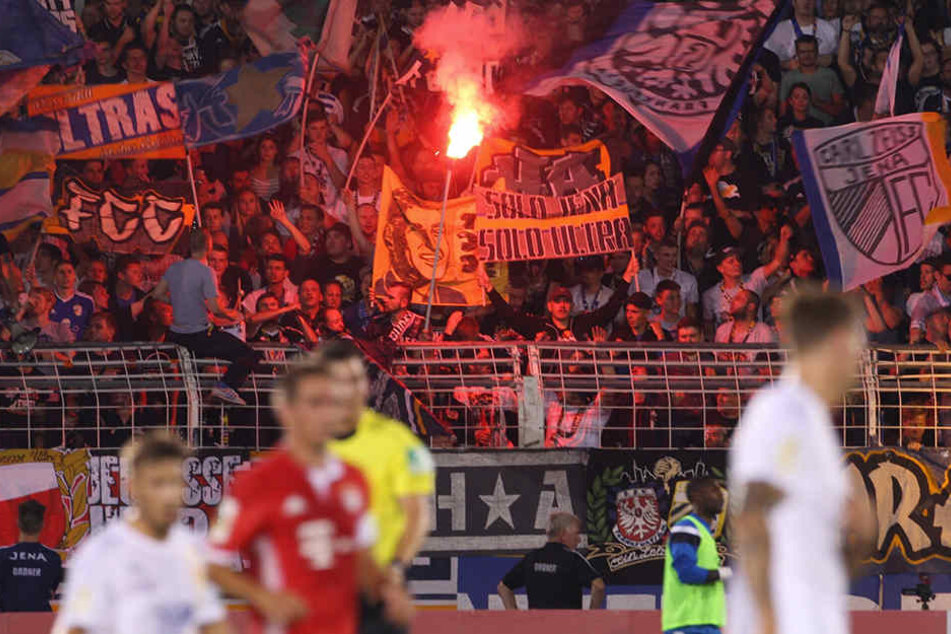 Jena-Fans zünden während der ersten Runde des DFB-Pokals gegen den FC Bayern München eine Pyrofackel.
