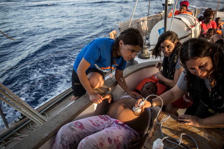 Eine schwangere Frau wird auf dem Rettungsboot untersucht.