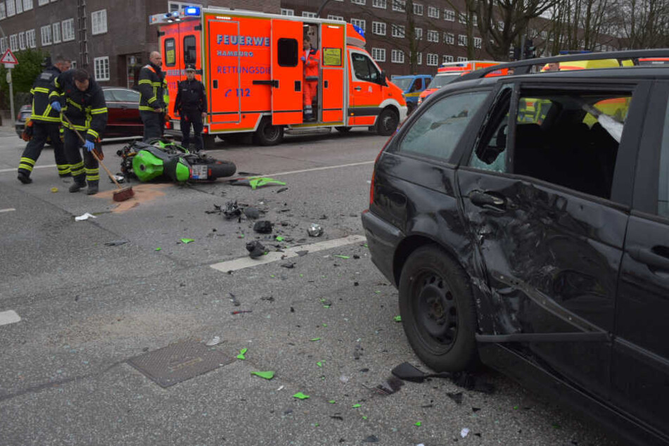 Die Tür des Autos wurde eingedrückt, die Scheibe zerscheppert. Abgerissene Teile des Motorrads liegen auf der Straße.