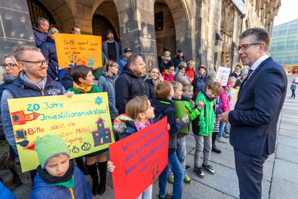 Bürgermeister Ralph Burghart (49, CDU) sprach mit protestierenden Eltern und Schülern vor dem Rathaus. Sie kämpfen für eine grundhafte Sanierung der Grundschule Klaffenbach.
