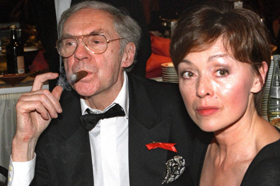 An einer Zigarre zieht Schauspieler Harald Juhnke neben seiner Frau Susanne bei einer Gala. Seine Karriere dauerte 50 Jahre.
