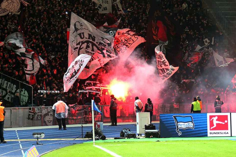 Fans von Eintracht Frankfurt brennen vor Spielbeginn mit Bengalos ab.