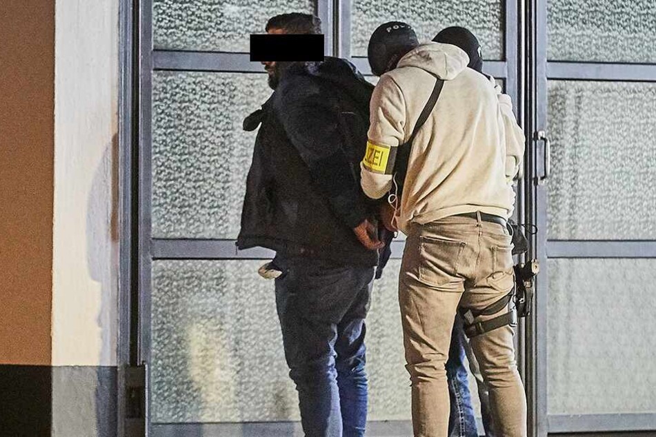 Einem Verdächtigen werden von einem SEK-Beamten Handschellen angelegt.