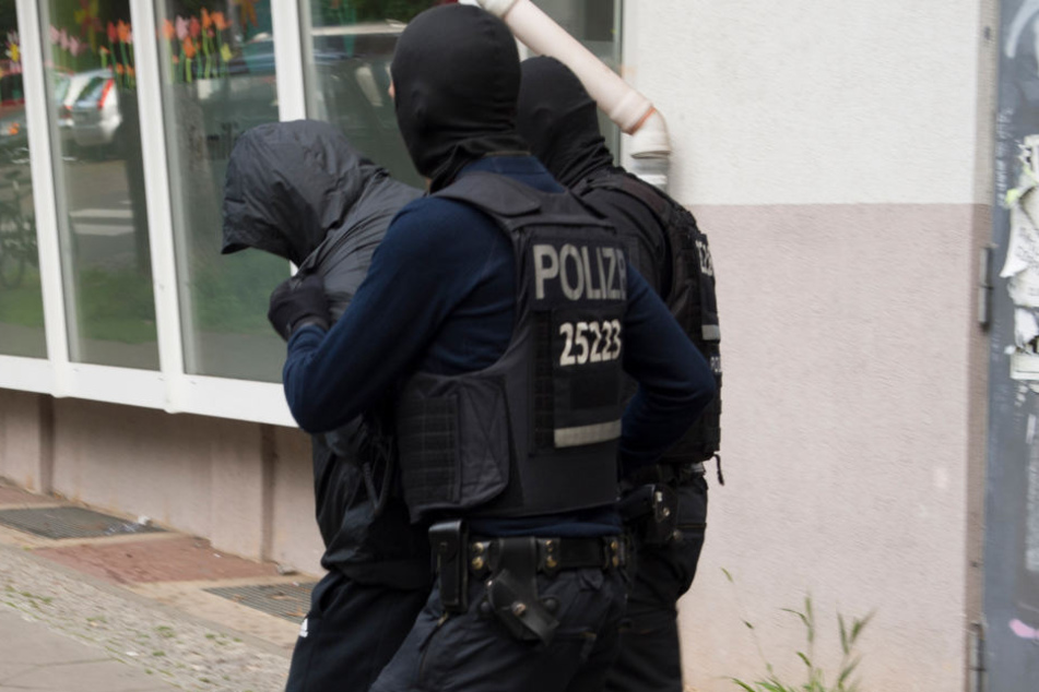 Berliner Polizisten führen einen Verdächtigen ab. (Symbolbild)