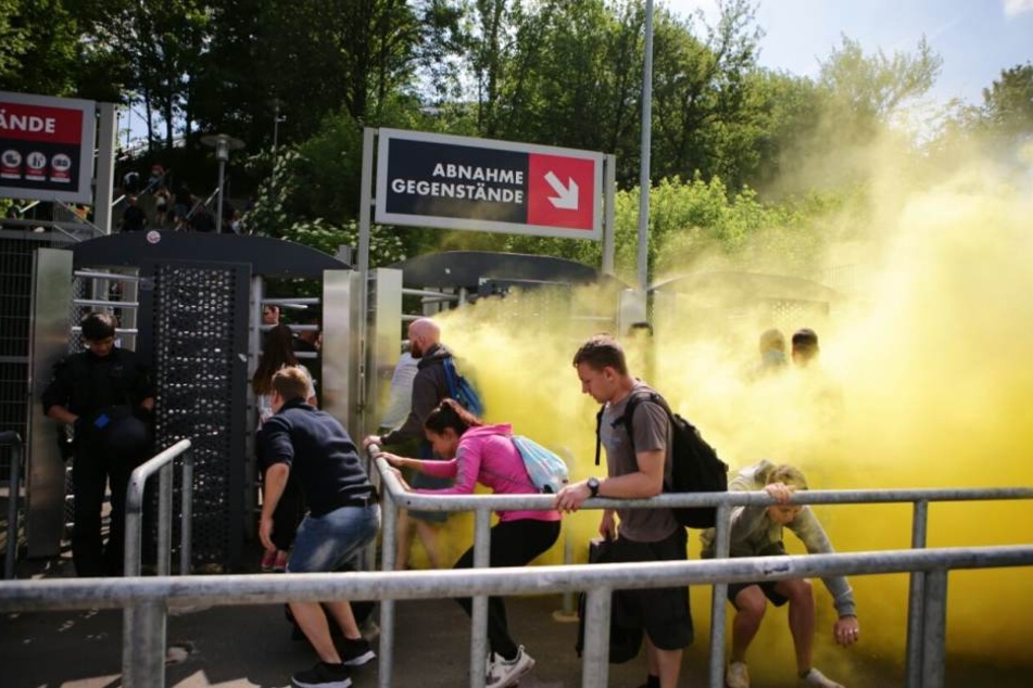 Rauchbomben wurden gezündet, Fans hasteten unter den Absperrungen hindurch.