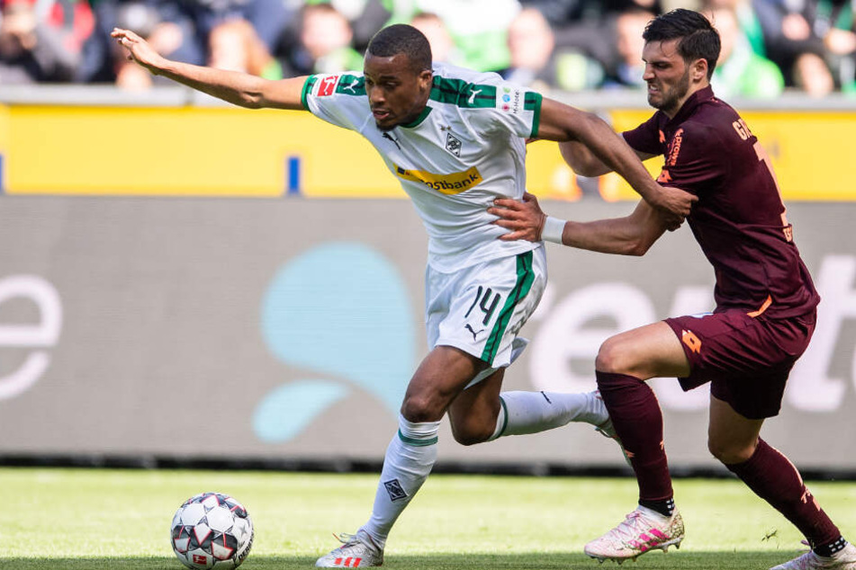 Gladbachs Alassane Pléa am Ball, Hoffenheims Florian Grillitsch will auf der Jagd nach ihm.