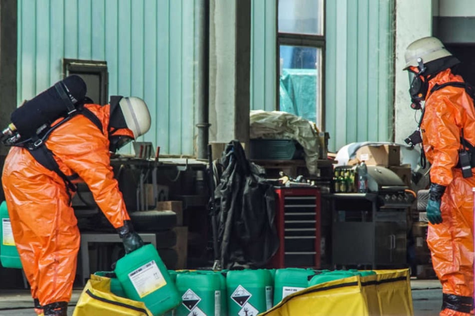 Feuerwehrmänner in Schutzmontur bei ihrer Arbeit auf dem Firmengelände.