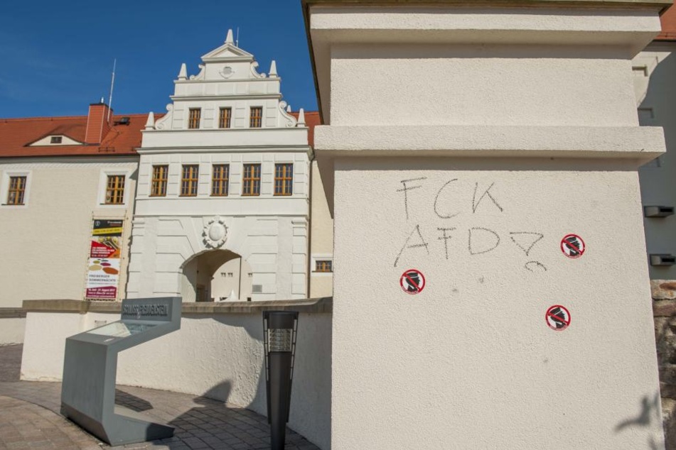 An mehreren Mauern rund um Schloss Freudenstein wurden Schriftzüge und Aufkleber angebracht.
