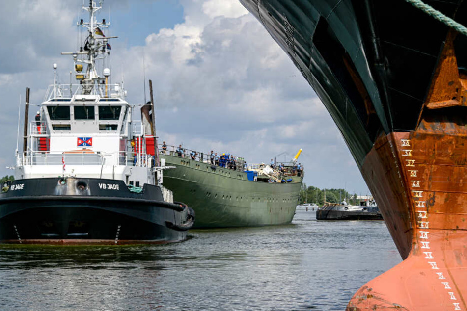 Ein Schlepper zieht den Rumpf der Gorch Fock über die Weser.
