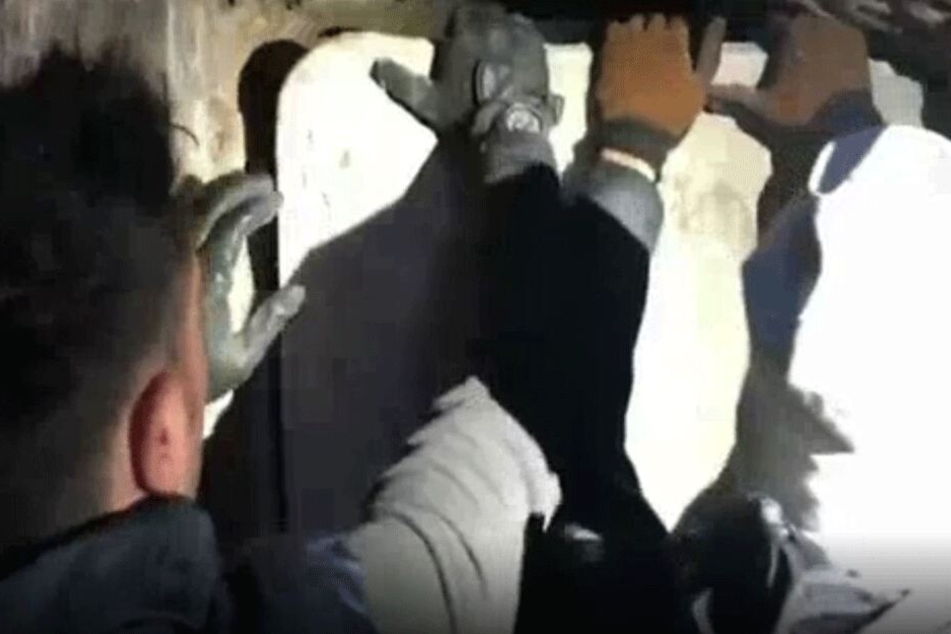 Die Beamten öffneten das Grab.