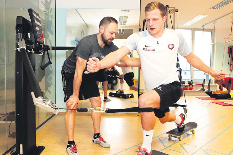 Schon beim Anblick sind die Qualen zu erkennen: Nicky Adler mit Sporttherapeut Daniel Förster an der Beinpresse. Mit seinem kaputten rechten Bein zieht er die Gewichte.