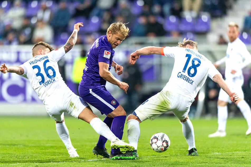 Ja, wer hat denn nun den Ball? Die Heidenheim Niklas Dorsch und Sebastian Griesbeck nehmen Aues Jan Hochscheidt in die Zange.