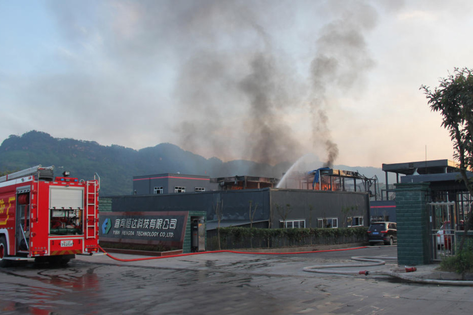 Einsatzkräfte der Feuerwehr löschen den Brand in einem Industriepark.