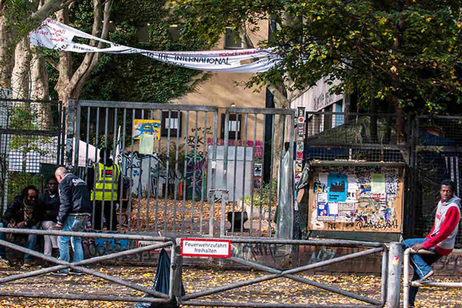 Flüchtlinge und einige Unterstützer sitzen November 2014 in Berlin vor der von Flüchtlingen besetzten ehemaligen Gerhart-Hauptmann-Schule in Kreuzberg.