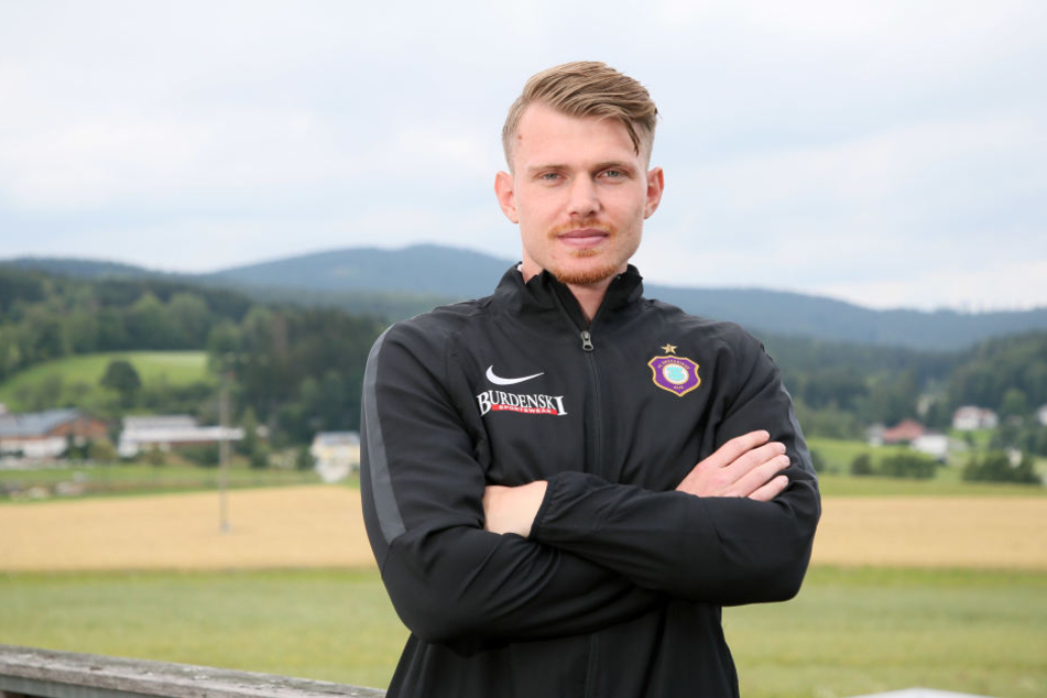 Steve Breitkreuz steht mit verschränkten Armen vor der weiten Landschaft rund um Bad Leonfelden. Aues Verteidiger muss sich derzeit in Geduld üben und darf sein Knie nicht überlasten.