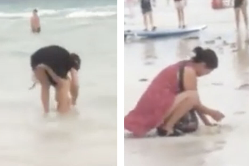 Während das Mädchen von einer Person im Wasser gesäubert wurde, vergrub die mutmaßliche Mutter die vollgemachte Windel im weißen Sand.