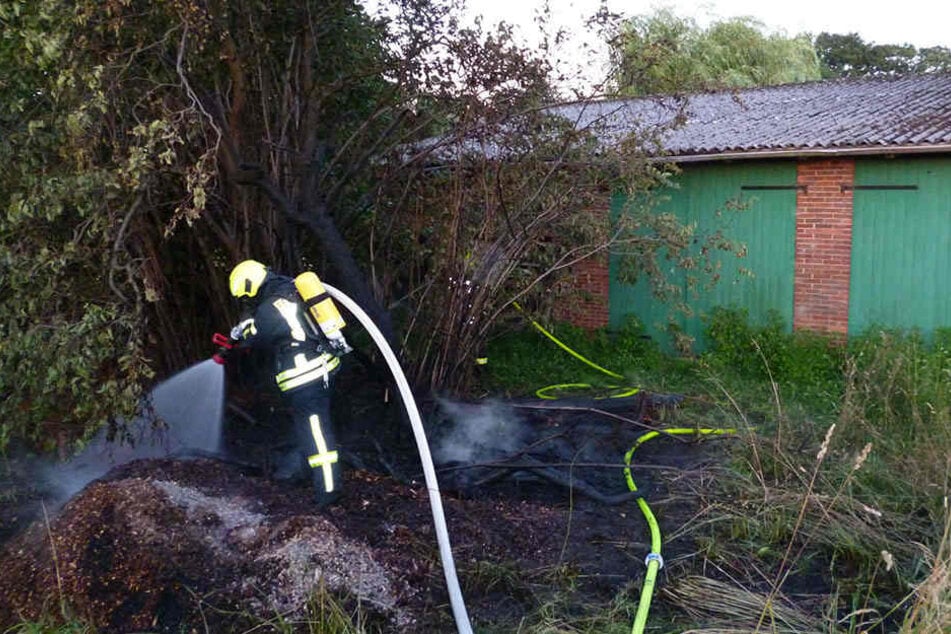 Ein Feuerwehrmann löscht die letzten Glutnester
