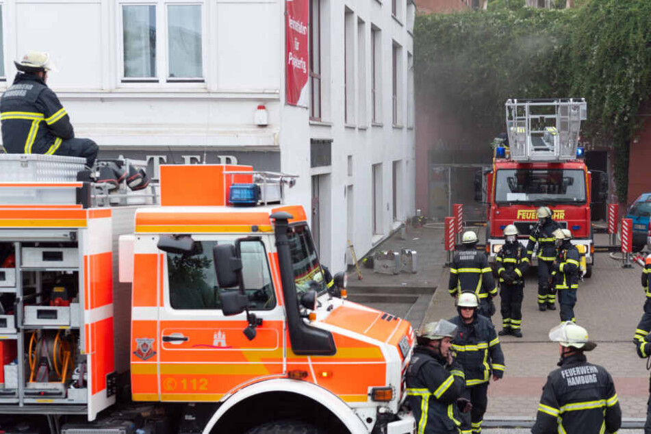 Der Qualm quoll aus der Tiefgarage, zahlreiche Feuerwehrmänner warten auf ihren Einsatz.