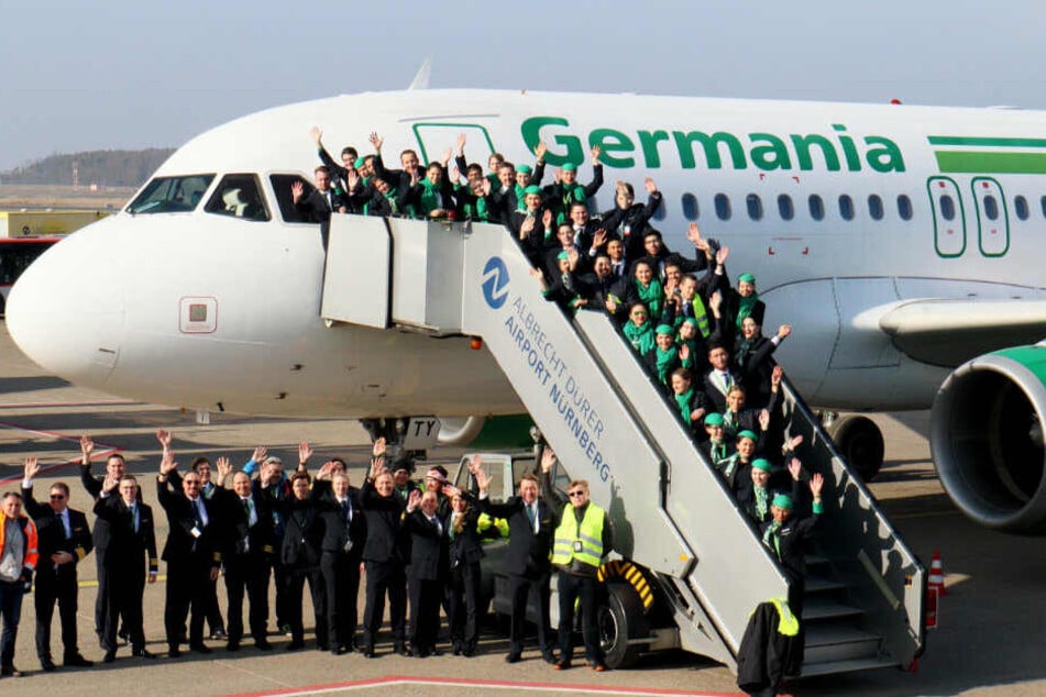 Mitarbeiter versammeln sich für ein Abschiedsfoto der insolventen Fluggesellschaft.