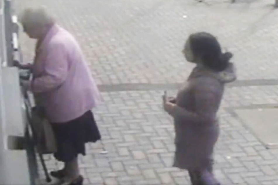 Die junge Frau nähert sich mit einem Zettel in der Hand.