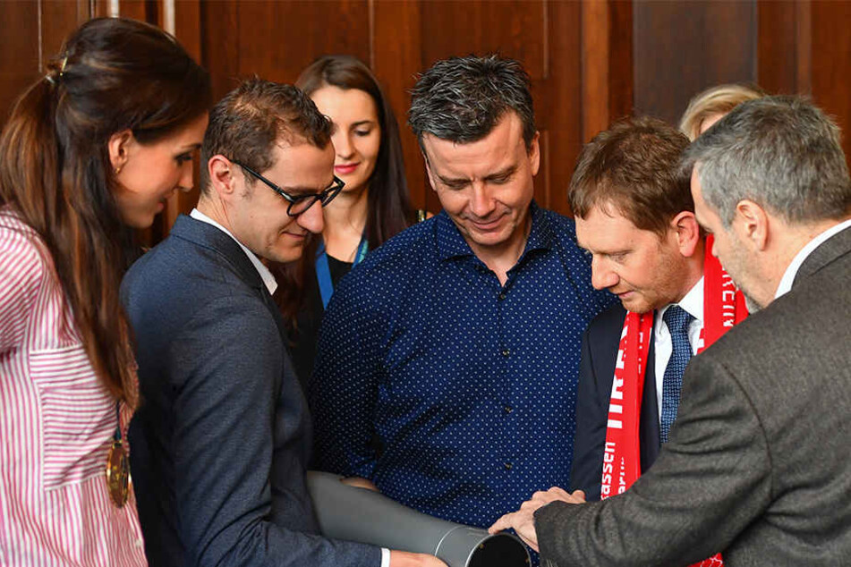 DSC-Vorstands-Chef Jörg Dittrich (r.) zeigt Ministerpräsident Michael Kretschmer (2.v.r.): "Hier sind wir auf dem Pokal als Sieger 2018 eingraviert." Außerdem von links: Kapitän Myrthe Schoot, Co-Trainer Andrea Ebana mit der Trophäe, Eva Hodanova und Chef