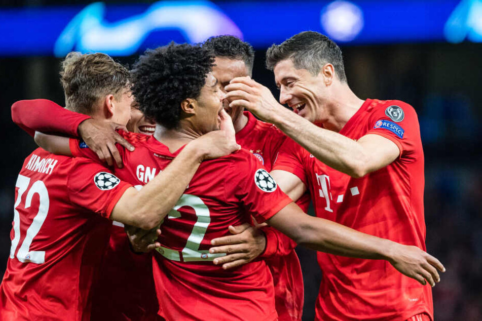 Joshua Kimmich (l-r), Serge Gnabry und Robert Lewandowski vom FC Bayern München jubeln über einen Treffer gegen Tottenham Hotspur.