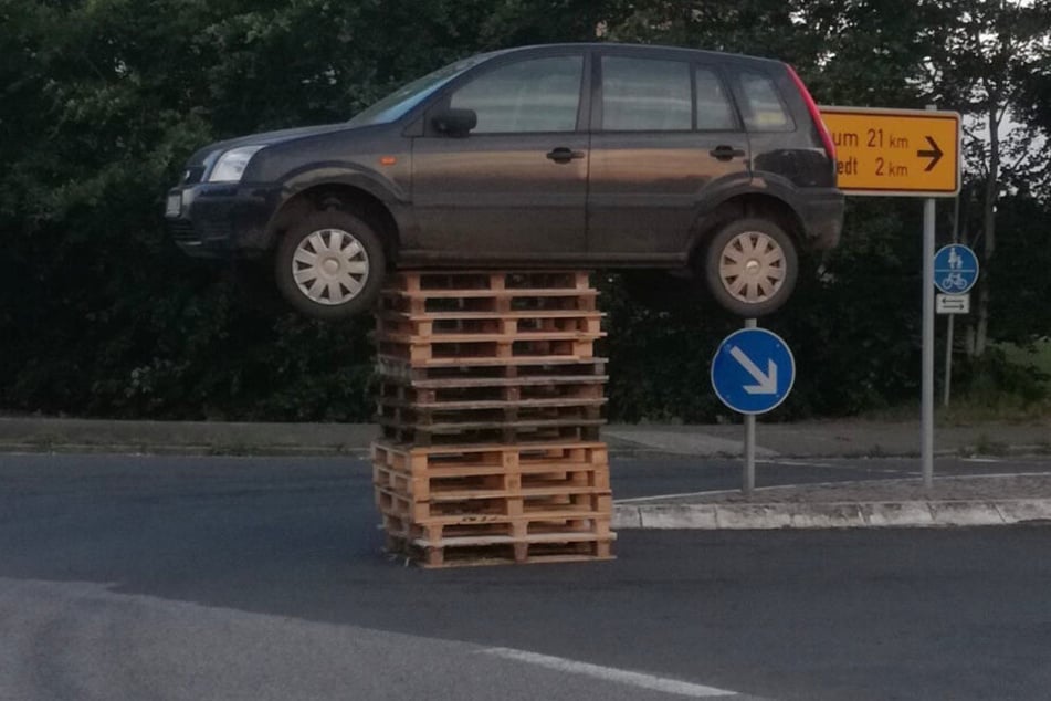 Das Auto steht auf 13 Paletten mitten auf einer Kreuzung.