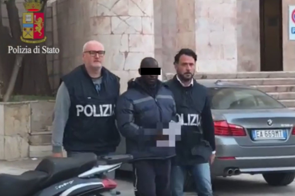 Der Mann wird von Polizisten abgeführt! Seine Opfer hatten ihn auf offener Straße wiedererkannt.