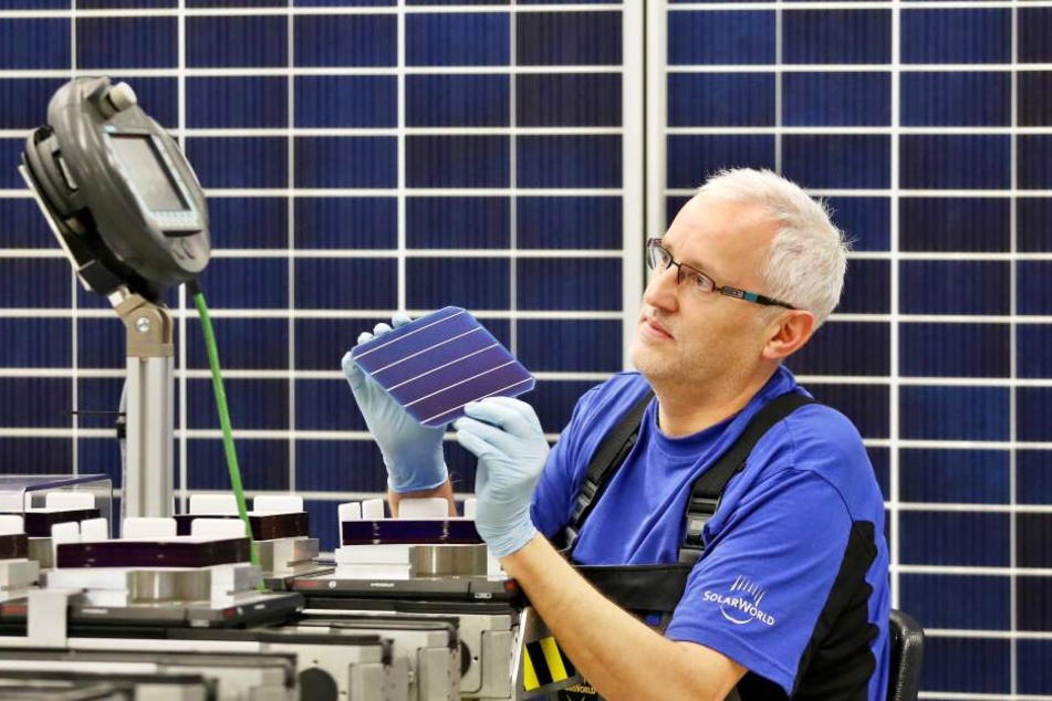 Jörg Liebscher, Mitarbeiter der Modulfertigung bei Solarworld, prüft eine PERC-Zelle.
