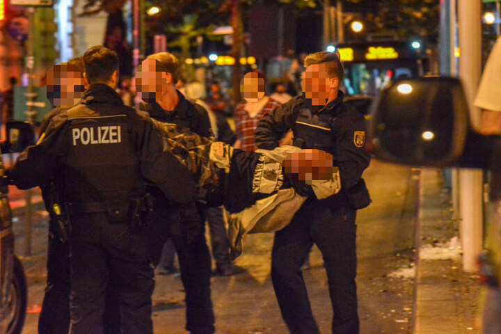 An Händen und Füßen gefesselt brachten die Polizisten einen Mann aus der Gruppe aufs Revier. Augenzeugen beschrieben die Maßnahmen als "unverhältnismäßig" und "brutal".