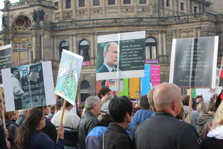 Schilder werden bei PEGIDA hochgehalten.