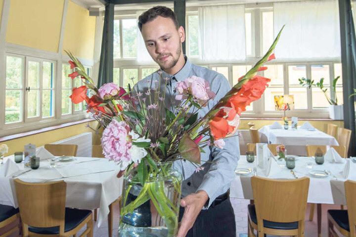 Christian Meinhold (27) dekoriert das Restaurant Villa Esche mit einem
frischen Blumenstrauß.