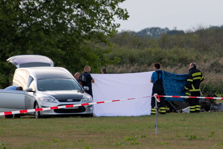 Die Leiche des tödlich verunglückten Piloten wird nach dem Absturz von einem Kleinflugzeug auf einem Feld zwischen dem Ortsteil Badingen und Gransee in eine Bestattungswagen verladen.